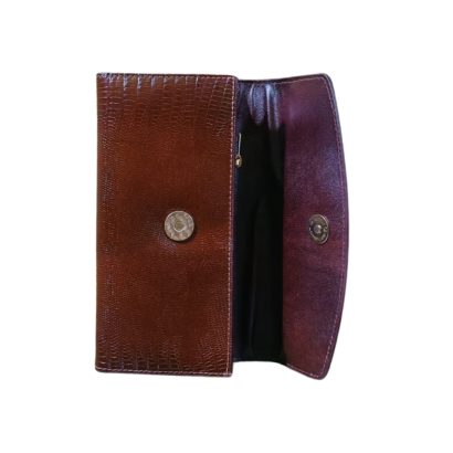 "Interior view of a dark brown lizard-embossed leather long wallet with snap button closure and spacious compartments."