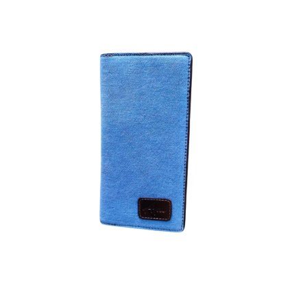 Front view of a blue denim long wallet featuring a brown leather brand patch at the bottom corner.