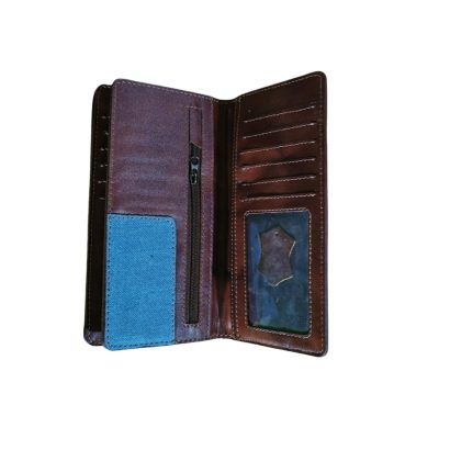 Interior of a brown leather long wallet featuring a blue denim lining, zipper pocket, multiple card slots, and a clear ID window.