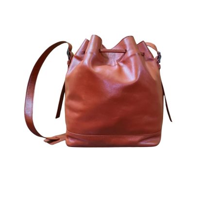 Brown leather bucket bag for women with adjustable sling strap and drawstring closure