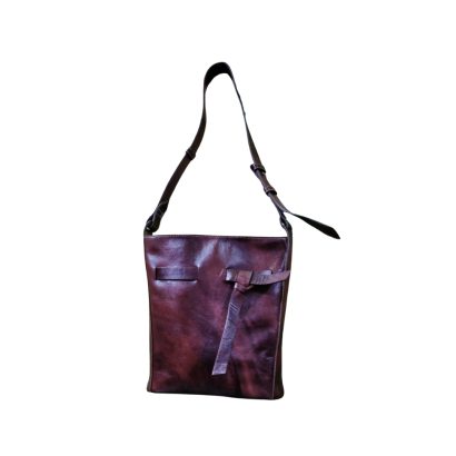 "Women’s brown leather shoulder bag with adjustable strap and minimalist knot detail."