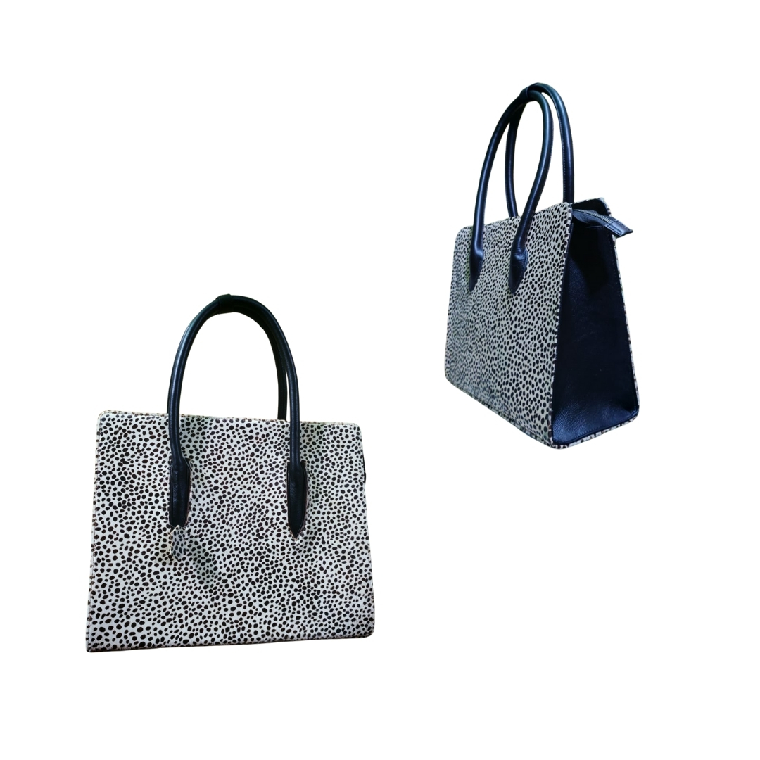 Black and white textured women’s tote bag with black handles shown from front and side angles.