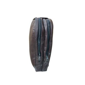 Side view of brown leather laptop backpack showing dual zipper closure and slim profile