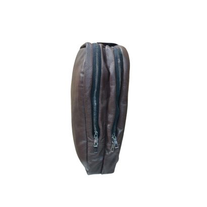 Side view of brown leather laptop backpack showing dual zipper closure and slim profile