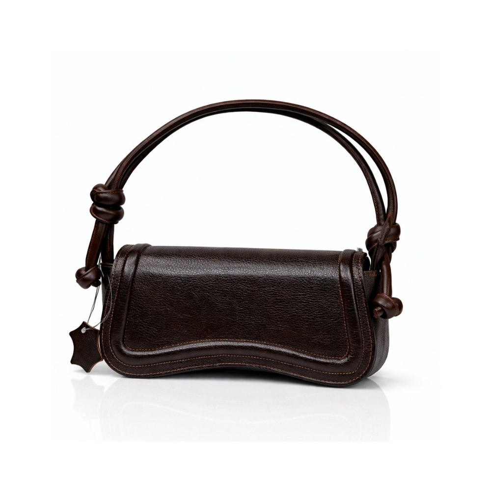 Dark brown leather shoulder handbag with curved flap and knotted straps on white background