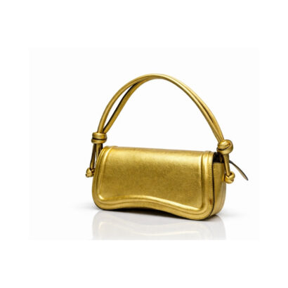 Metallic gold leather shoulder handbag with curved flap and knotted straps on white background